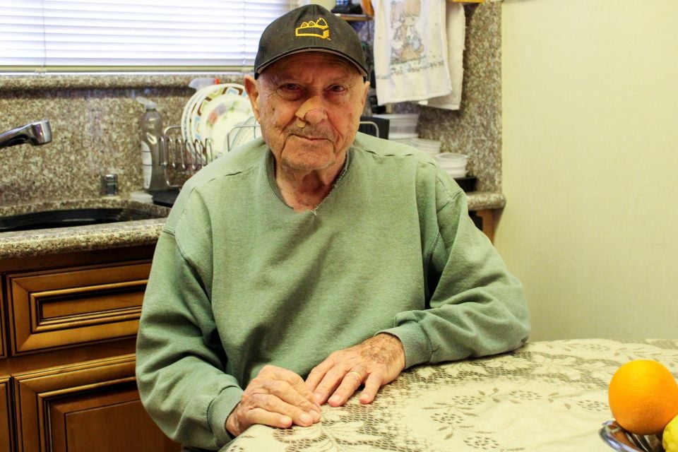 image shows a man seated at a table